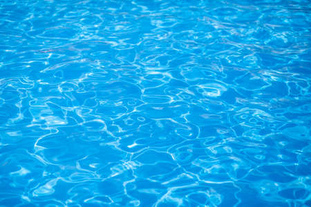 Water background, ripple and flow with waves. Summer blue swiming pool pattern. Sea, ocean surface. Overhead top view with place for text.の写真素材