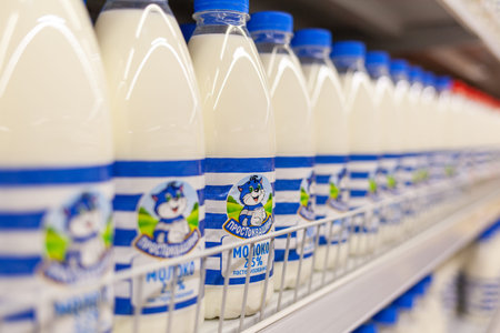 Bottles of milk on the shelf of the store. Selection and purchaseの写真素材