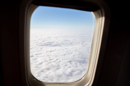 Airplane flight. Wing of an airplane flying above the clouds. View from the window of the plane....