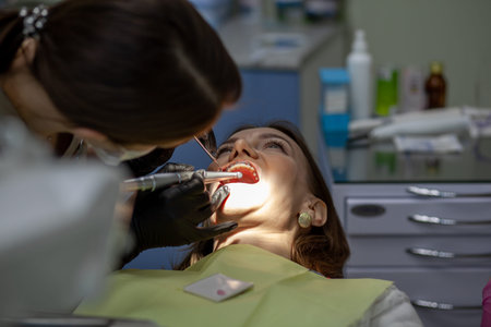 The process of removing braces.Beautiful woman in dental chair during procedure of installing braces...