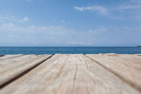 Wooden planks on the pier above the blue sea. Wooden planks on top of the water.の写真素材