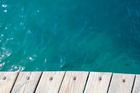 Wooden planks on the pier above the blue sea. Wooden planks on top of the water.の写真素材