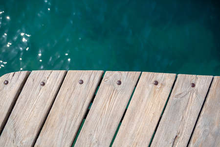 Wooden planks on the pier above the blue sea. Wooden planks on top of the water.の写真素材