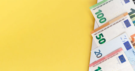 Different Euro bills on a laptop background and on a yellow background