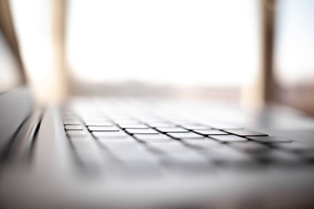 Close-up of the keyboard of an open laptop ready to work on the table. Side view, selective focus on the keyboard. The concept of computer security and work on the Internet.の写真素材