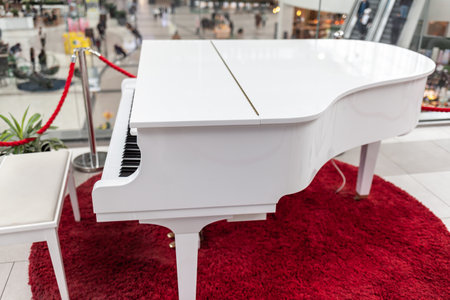 A white grand piano in a shopping mall close-up. Image for design. Space for text.の写真素材