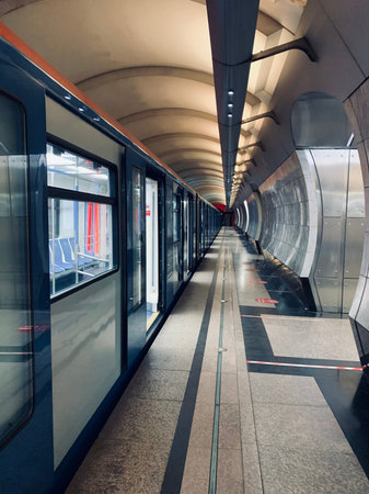 An empty underground metro station after a working day. The doors of the cars are open for...