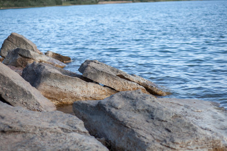 Seascape with rocks and large stones. sea shore. stone cliff. cloudy sky. The beauty of the wildの写真素材