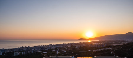 Beautiful sunset over the mediterranean sea and the cityの写真素材