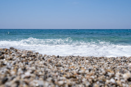 Sea waves run on the shore of the sea or ocean.