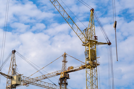 crane and a building under construction against a blue sky background