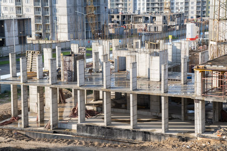 Builders work on large construction sites, and there are many cranes