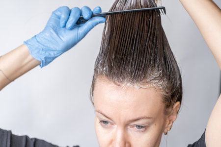 Close-up of a womans head in the process of hair coloringの写真素材