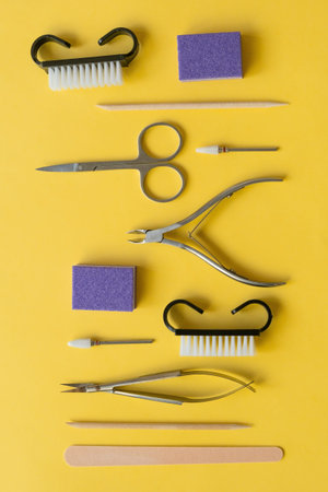 Professional manicure tools on yellow background. Manicure set.