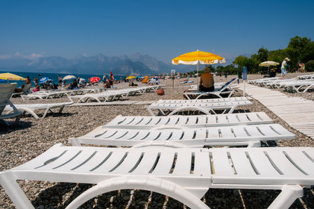 People Crowd Relaxing On Beach. Swimming people in seaのeditorial素材