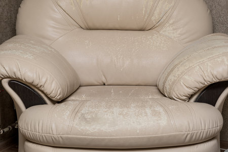 Defects on a white leather sofa. Damaged to leather furniture.の写真素材