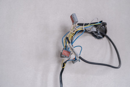 Apartment renovation. Electrical wiring. Wires sticking out of the wall.