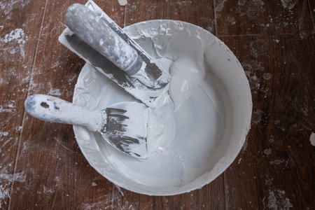 Applying decorative putty. White abstract texture of surface covered with putty