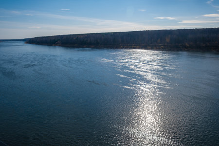 Beautiful, wide autumn river among forests and rocky shore.の写真素材