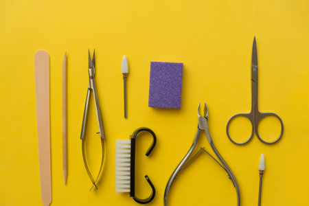 Professional manicure tools on yellow background. Manicure set.