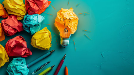 Idea concept with crumpled paper and light bulb on green backgroundの素材