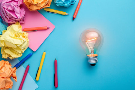 Idea concept with crumpled paper and light bulb on blue backgroundの素材