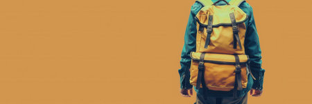 A stylized yellow backpack on a person, set against a minimalist orange background. The image symbolizes travel and adventure.の素材