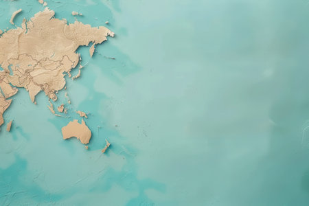 A simple, clean-lined image of a globe map, featuring the continents of Asia and Australia in a beige tone, against a bright turquoise background.の素材