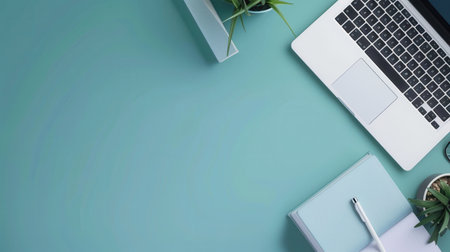 A flat lay image showing a modern learning workspace with a laptop, textbooks, and a pen.の素材