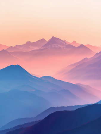 At dawn, the sun lights up the peaks of a mountain range, creating a tranquil scene with pastel skies.の素材