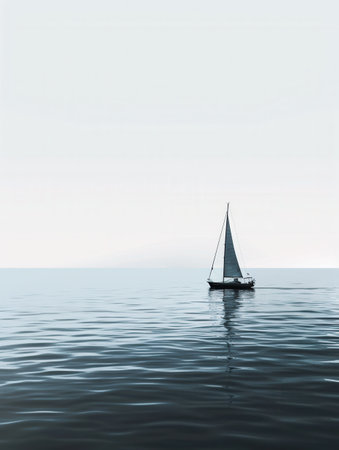 A minimalistic silhouette of a sailboat on calm, blue water with a clear sky.の素材