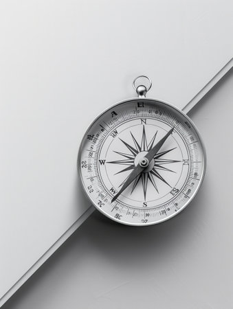 A silver compass with clear lines sits on a white background, offering a simple and symbolic image for navigation apps and travel services.の素材