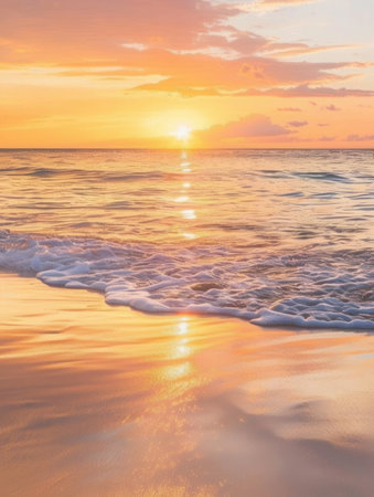 A stunning sunset over the ocean, with warm orange-pink skies reflecting on the water. The image features a wave breaking on the sandy shore.の素材