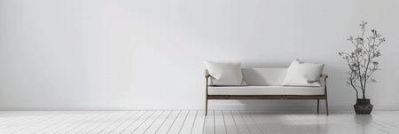 A white sofa with two pillows sits in a minimalist living room with white walls and a white wooden floor. A black and white plant is in a wicker basket to the right of the sofa.の素材