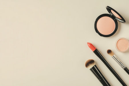A serene display showing a lipstick, makeup brushes, and powder in a minimalist style against a light background, highlighting beauty essentials.の素材