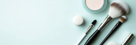 Cosmetic products are neatly arranged on a light background, highlighting lipstick, brushes, and powder for a simple, elegant look.の素材