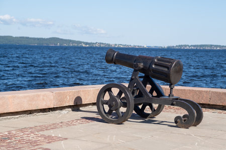 The cannon stands prominently on the shores of Lake Onega, overlooking the water and highlighting local historical significance.の写真素材