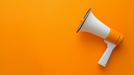 A bright megaphone sits idle against a smooth orange background, highlighting its design against a monochromatic color scheme.の素材