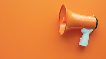 An orange megaphone leans against a vividly colored wall, emphasizing communication in a simple and engaging environment.の素材