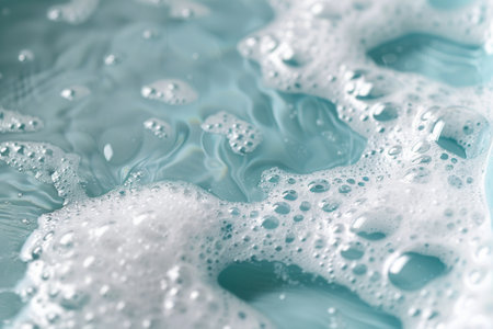 A close-up view of soft, bubbly foam floating on calm water, creating a serene and relaxing atmosphere for a peaceful bath experience.の素材