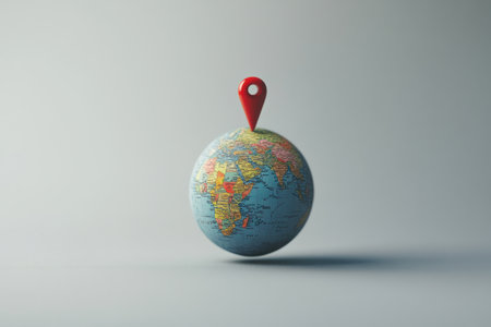 This minimalist globe prominently features a location pin, marking a specific travel destination and inspiring exploration and adventure.の素材