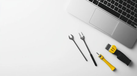 A laptop is placed on a clean workspace alongside various tools ready for computer repair and maintenance tasks, highlighting organization.の素材