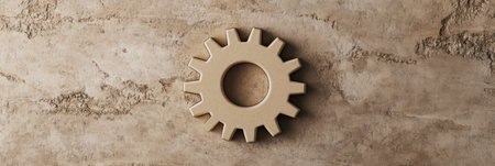 A beige gear symbol rests on a rough, textured surface, illustrating themes of industry and engineering in a simple yet impactful design.の素材