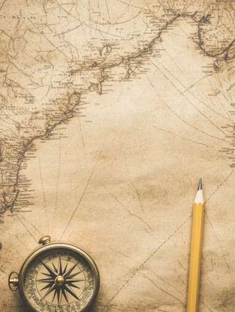 Vintage map displays intricate details with a compass and a pencil nearby, inviting ideas for adventures and journeys across unknown territories.の素材