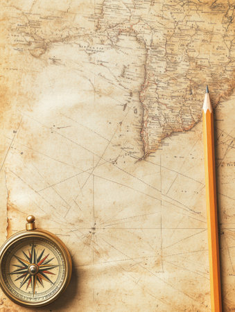 A vintage map lays open, accompanied by a compass and a pencil, inviting exploration and planning for new adventures.の素材