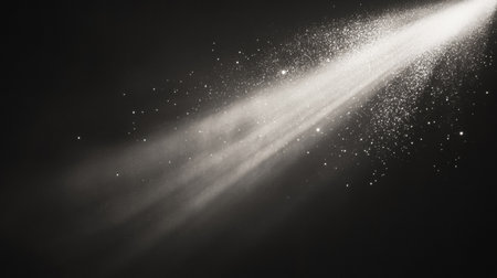 A narrow shaft of light pierces through deep darkness, creating a mesmerizing effect with luminous particles dancing in the air.の素材