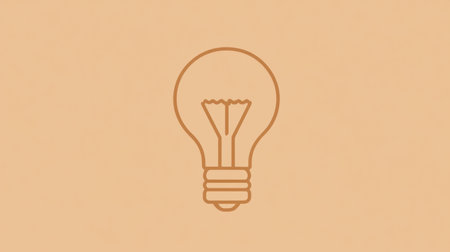 A light bulb is depicted against a warm orange background, symbolizing ideas and inspiration in a simple, clean design that enhances focus.の素材