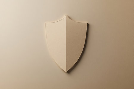 A shield emblem is depicted in neutral tones, emphasizing a minimalistic design against a smooth, understated background.の素材