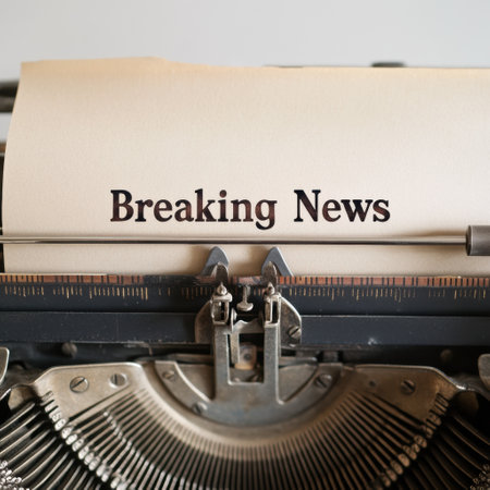 A vintage typewriter types out breaking news on a blank sheet, capturing the essence of traditional journalism in a nostalgic way.の素材