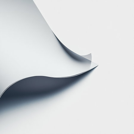 Glossy paper curls softly at the edge, catching light and creating subtle shadows, showing minimalism and design elegance.の素材
